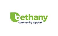 The image shows the logo of Bethany Community Support. The logo features a green, stylized "B" resembling a leaf, followed by the word "ethany" in green lowercase letters. Below this, "community support" is written in smaller blue lowercase letters.