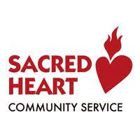 Logo for Sacred Heart Community Service. The logo features red text stating "Sacred Heart" with a stylized red heart and flame design, and black text below stating "Community Service" on a white background.